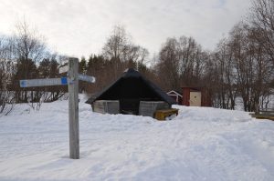 Hütte und Schild im Schnee